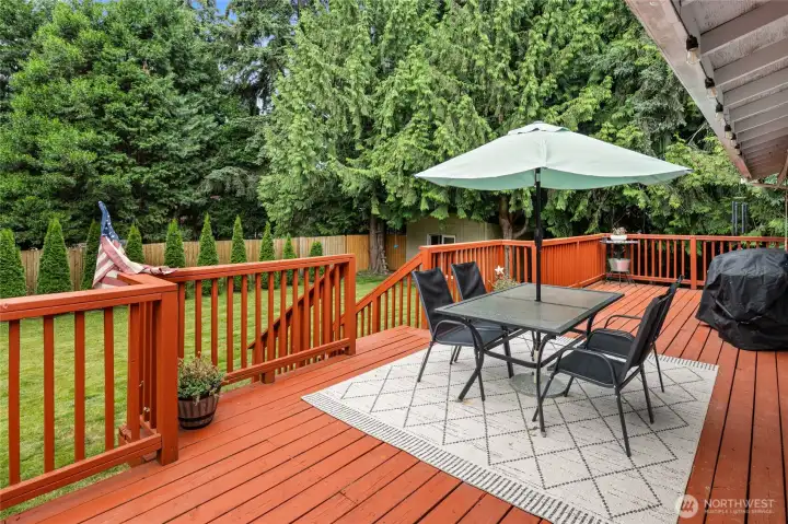 Large deck overlooking the private backyard.