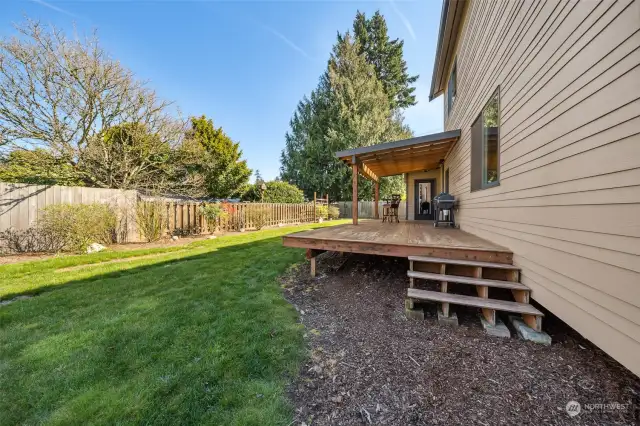 The large fenced backyard is a welcoming oasis, offering ample room for gardening, play, and pets to roam freely.