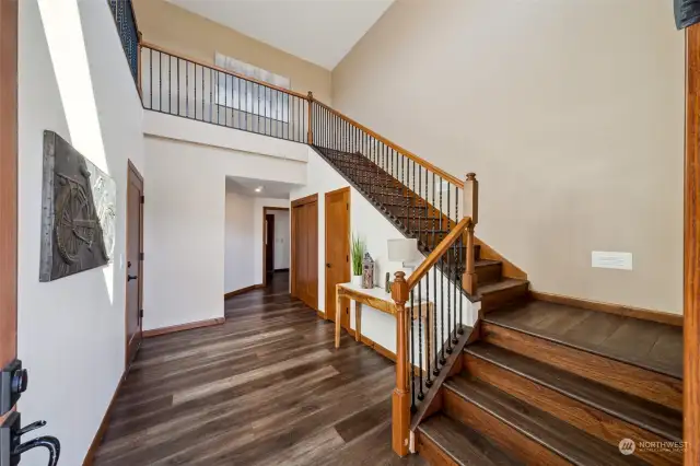 Step into elegance with the stunning entryway featuring soaring, airy ceilings and a graceful wraparound open balustrade.