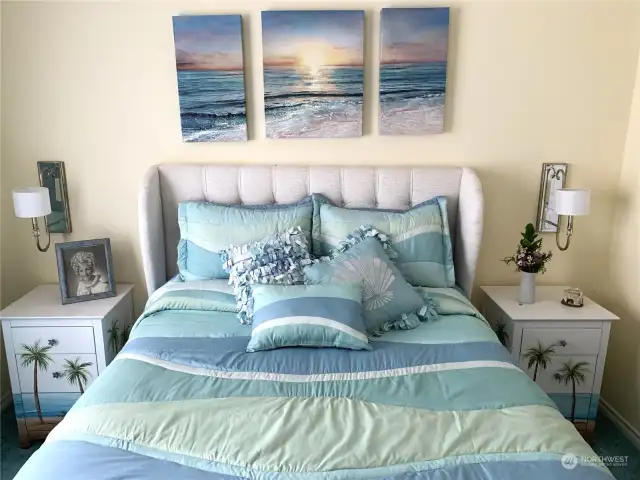 Another view of bedroom features wall lamps and shows  room for night stands