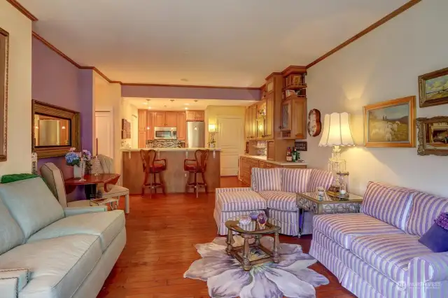 Living room looking back at kitchen showing dining alcove.  Table can be pulled out to seat more people