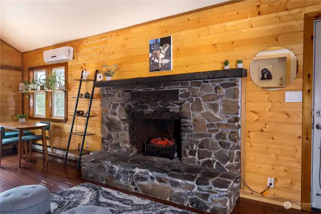 The beautiful stone fireplace serves as a captivating centerpiece. Although it was capped off years ago, it still adds an elevated touch of ornamental charm to the space.