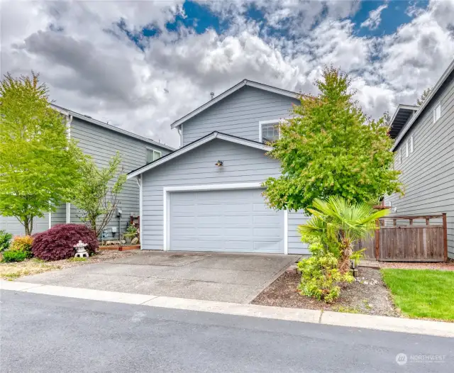 Full-sized two-car garage and driveway parking access from the back.