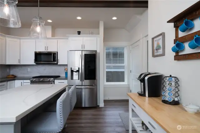 View in kitchen with pantry door to the right of photo and door to the lower level of the home featured next to the window.