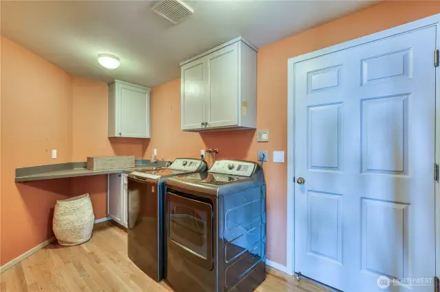 Come in through the 3-car garage to this well-equipped laundry room.