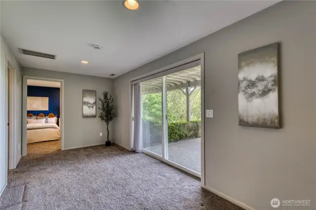 At the bottom of the stairs, between the large family/rec room and the bed/bath is a set of sliders to the patio and backyard.