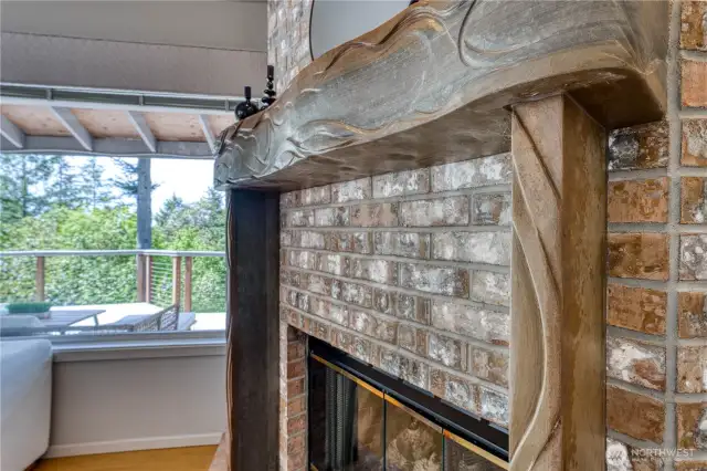 This gas fireplaces has a custom carved stone mantel created by a local artisan.