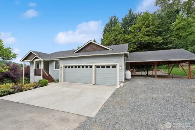 From driveway showing 3 car garage plus the 2 car carport.