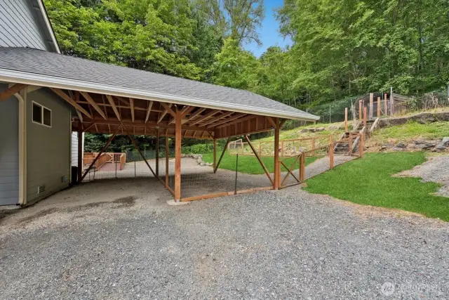 Close up of carport showing stairs up to chicken coop.