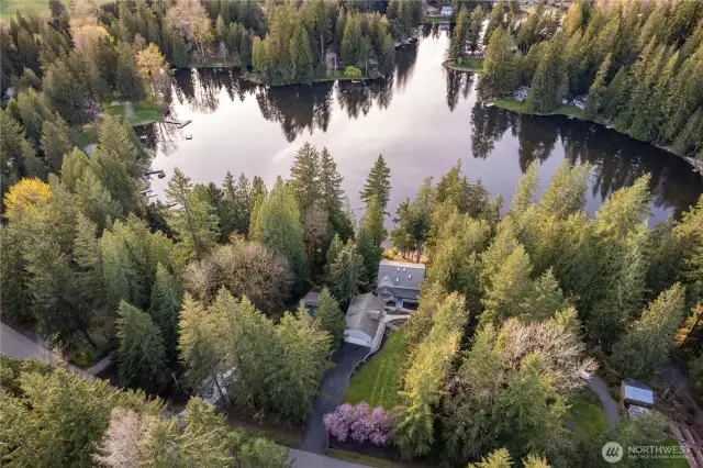 Lake Marcel waterfront home looks west across the lake. Upper landscaping has a large flat lawn, garden space, and pre-wiring for powered driveway gate.