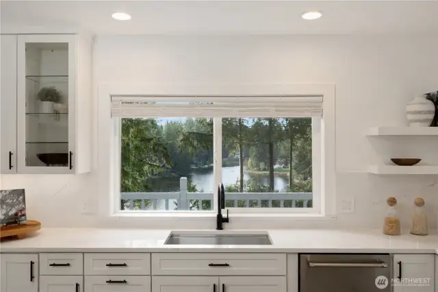A gourmet kitchen with a western lake view.