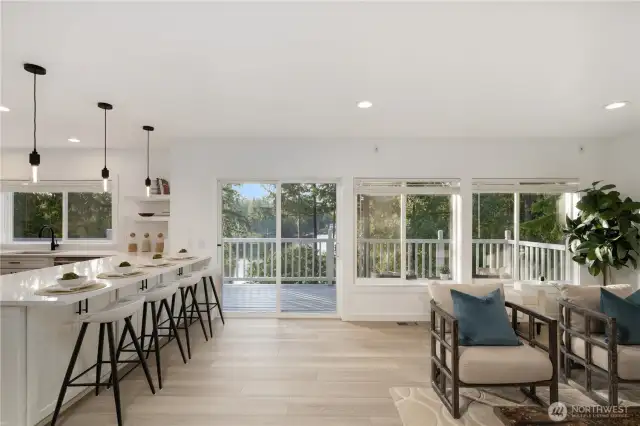 Spacious casual room with gas fireplace adjoins the gourmet kitchen with a wall of west facing windows to capture the view of the lake.