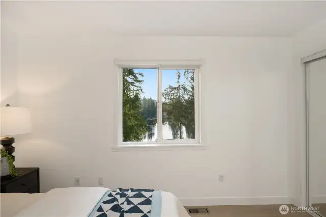 Secondary bedroom #1 (upstairs) overlooks the glistening lake to the west.