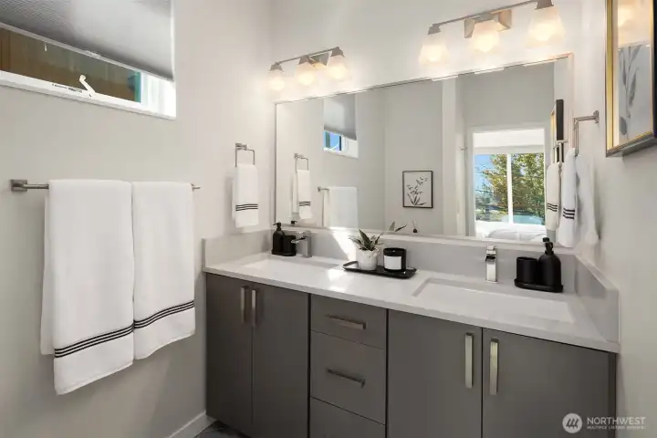 Primary bathroom-double vanities, and marble accents throughout.