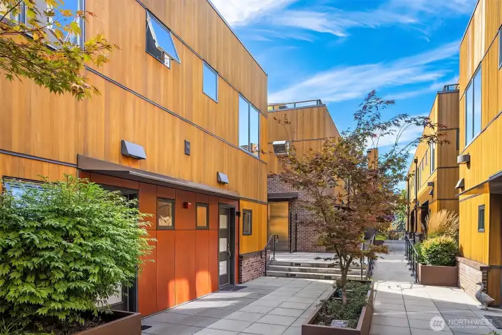 A beautiful courtyard allows you to interact with your neighbors or keep to yourself.  This is an elevated space up off the street and private to the building.  It feels like a neighborhood block.