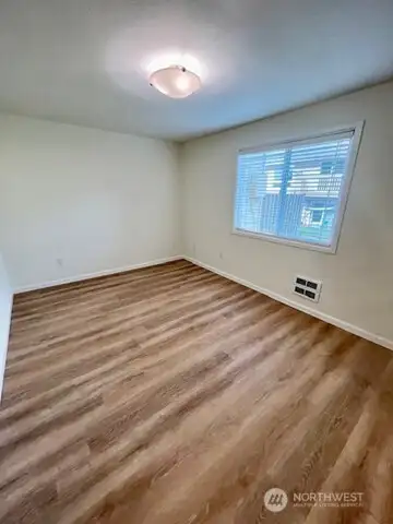Bedroom with professionally installed NEW Luxury Plank Flooring & New Paint!