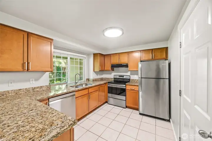 So much room in this kitchen! Ceramic tile flooring, Stainless steel appliances, maple cabinetry and granite countertops. Lots of storage!