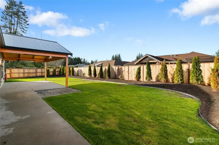 Private, fully fenced backyard with oversized heated patio