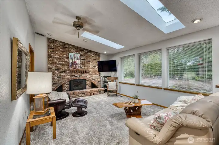 Newer gas fireplace insert with fan to circulate heat keep this room cozy all winter long.