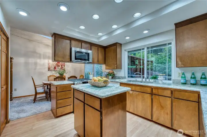 Spacious kitchen with granite counter tops and new stainless appliances.