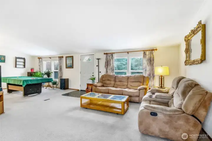 The living room and family room are side by side, creating a great room type of vibe for relaxing on one side and recreation on the other side.