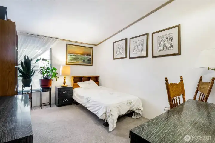 Bedroom #2 faces the front of the house. Look at all this space!  It even fits a desk!