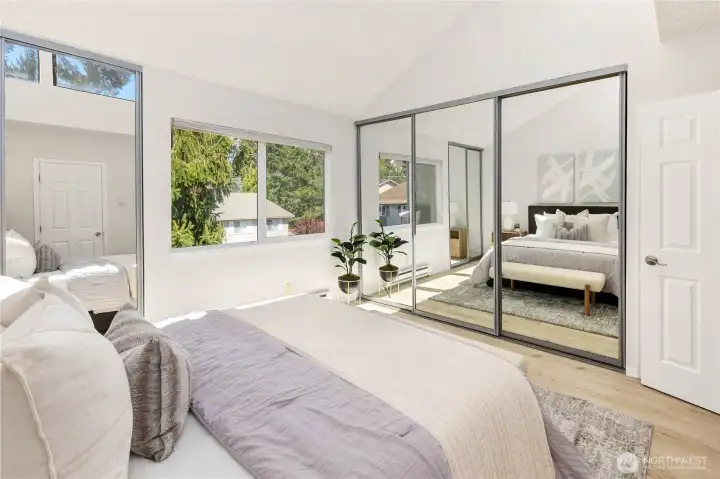 The primary suite features custom organizers, vaulted ceilings and updated bath.