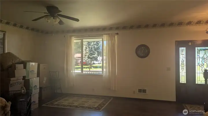 In the living room, you can see the front door. The seller is starting to pack.