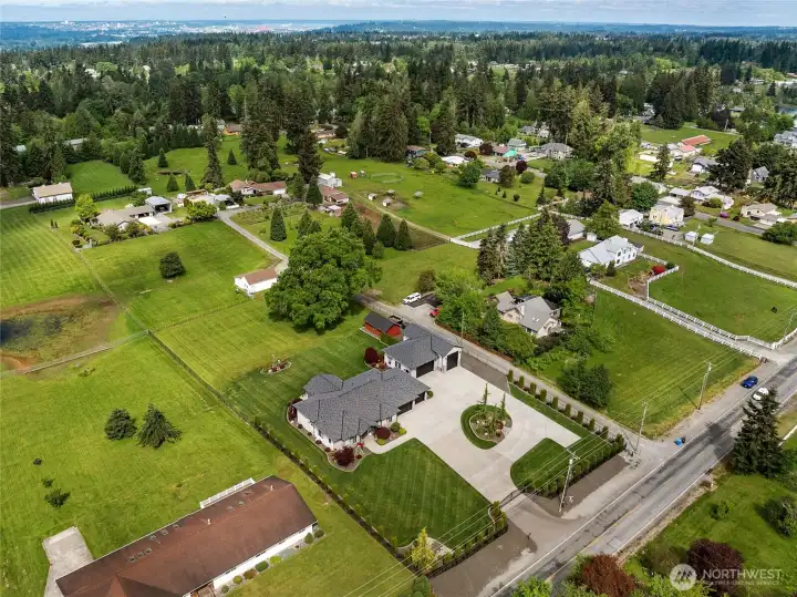 A beautifully composed exterior view of this meticulous estate showcasing the elegant rambler, expansive detached garage and shop with ample RV space, and a charming restored storage barn. A beautifully composed exterior view of this meticulous estate showcasing the elegant rambler, expansive detached garage and shop with ample RV space, and a charming restored storage barn.
