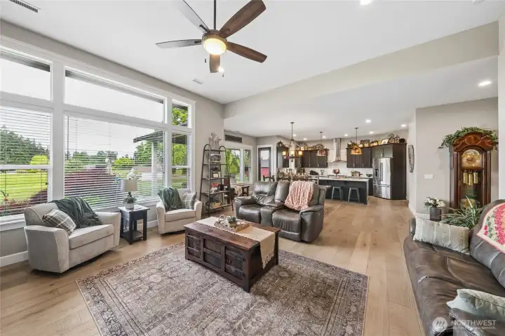 The beautifully connected open living spaces create an ideal setting for both everyday comfort and entertaining, seamlessly blending the light-filled living room, elegant dining area, and well-appointed kitchen into one expansive and welcoming gathering space. The beautifully connected open living spaces create an ideal setting for both everyday comfort and entertaining, seamlessly blending the light-filled living room, elegant dining area, and well-appointed kitchen into one expansive and welcoming gathering space.