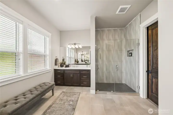 Another elegant view of the primary ensuite highlights the expansive fully tiled shower, offering a spa-like experience with sophisticated finishes and generous space. Another elegant view of the primary ensuite highlights the expansive fully tiled shower, offering a spa-like experience with sophisticated finishes and generous space.