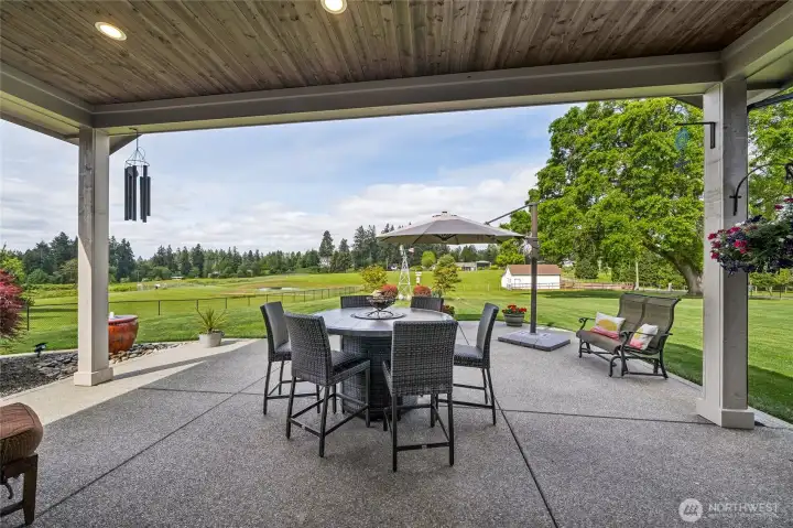 The large partially covered patio offers generous outdoor living space and a comfortable setting to relax or entertain, all while overlooking the picturesque, well-maintained acreage. The large partially covered patio offers generous outdoor living space and a comfortable setting to relax or entertain, all while overlooking the picturesque, well-maintained acreage.