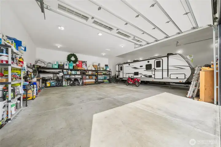 Interior of this ultimate detached shop featuring three spacious bays, including an impressive RV bay exceeding 44 feet in depth with a 14-foot-high door, offering exceptional versatility and storage. Interior of this ultimate detached shop featuring three spacious bays, including an impressive RV bay exceeding 44 feet in depth with a 14-foot-high door, offering exceptional versatility and storage.