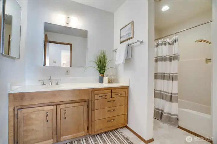Full guest bath with an oversized vanity and extra storage. Full guest bath with an oversized vanity and extra storage.