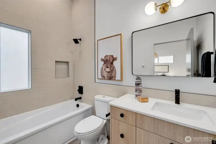 Ensuite to the second bedroom features a deep soaking tub with a custom tile surround. Ensuite to the second bedroom features a deep soaking tub with a custom tile surround.