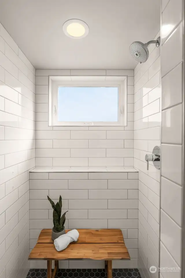 The secondary bathroom sports a spa-like walk-in shower, with bench and clerestory window.