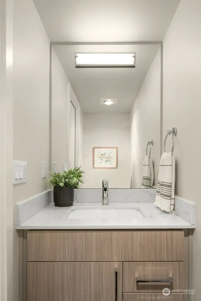 Adjacent to the walk-in shower is the quartz-topped guest vanity!