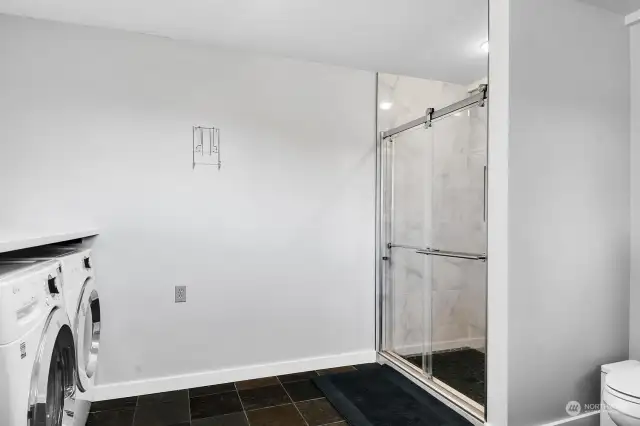 This shows the three-quarter bath and slate floor of the laundry room.