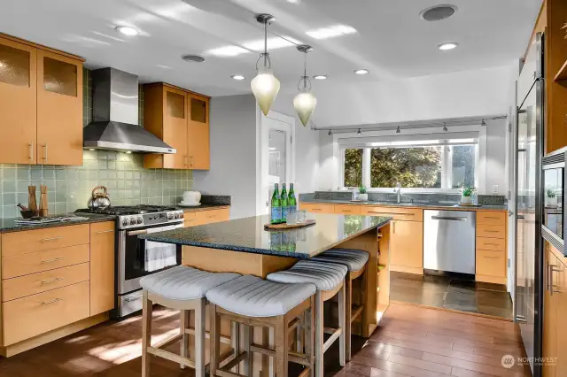 The kitchen features 2 (!) walk-in pantries, maple cabinets, Tibetan blue granite and custom lighting.