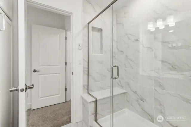 Oversized shower with seat & tile surrounds w/ semi frameless glass Colors and features will Vary- marketing purposes only