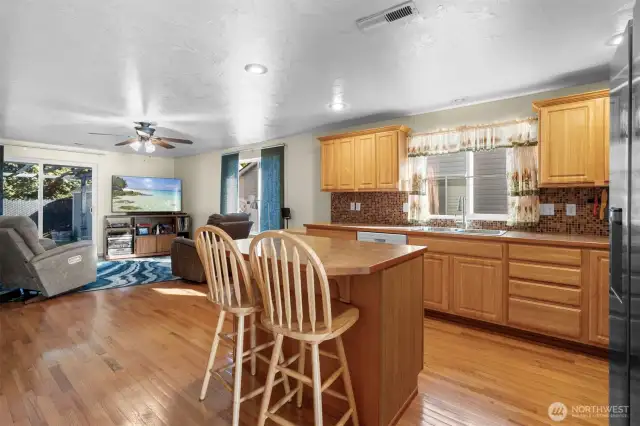 Kitchen opens to the Living room with ceiling fan.