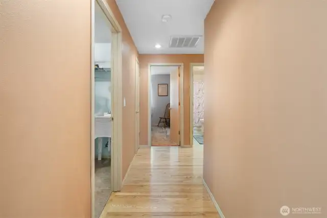 Hallway off living space leads to three bedrooms and two full bathrooms.