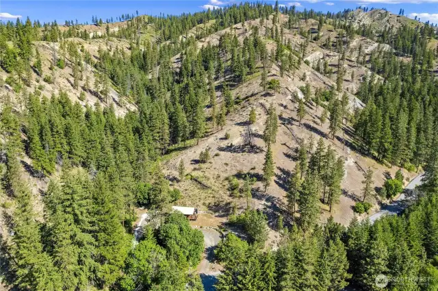 Aerial view of home, land, and neighboring properties
