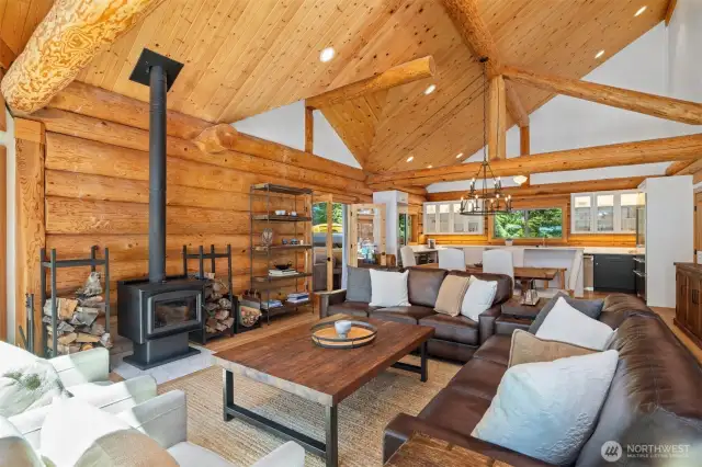 Thoughtfully designed open-concept living and kitchen area with refined finishes and bold log detailing, perfect for entertaining with style and ease.