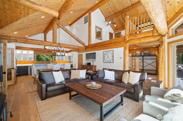 Soaring trusses and custom woodwork crown the vaulted living space, blending organic textures with polished contemporary design and effortless island charm.