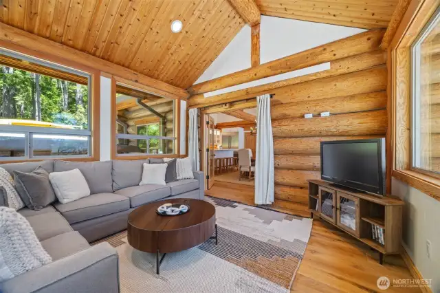 With log-accented walls, vaulted ceilings, and sliding French doors to the main living area, this versatile retreat blends coastal charm with refined design.
