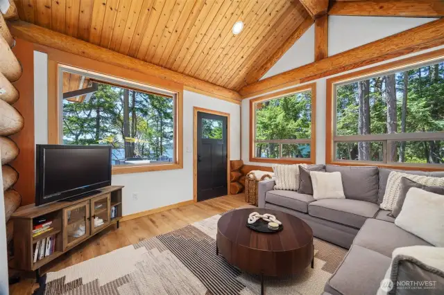 Wrapped in windows with serene ocean views, this secondary living space offers a quiet escape—ideal for movie nights or peaceful mornings on the coast.