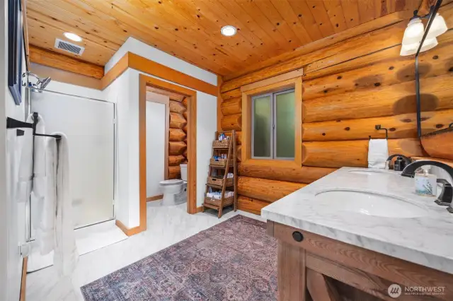 Private water closet and walk in show are showcased in the primary ensuite.