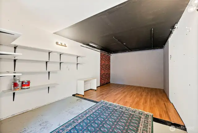 1 garage was converted to a studio with insulation and drywall.