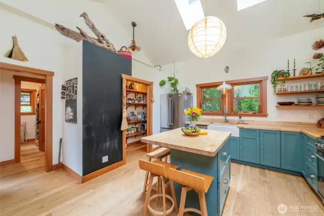 In the background is the walk-in pantry and through the hall is access to the laundry room and bathroom